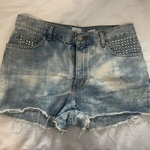 Vintage distressed Calvin Klein denim shorts with pocket studs.